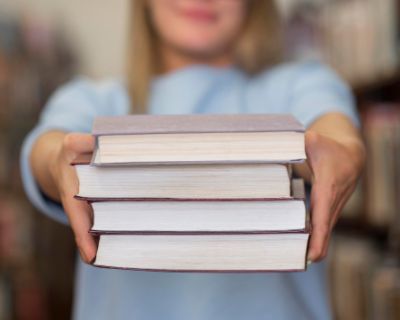 close-up-woman-holding-books